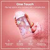 A pink children's water bottle, featuring unicorns, is held; its flip top opens with a single click. The bottle is shown against a pink background. “One Touch. Flip top opens one-handed with a simple click.” Additional features include: “Flips open with a simple click,” “One-handed use on the go,” “Triple lock security,” and “100% leak proof – no twisting, no leaks.” POD RECYCLON™